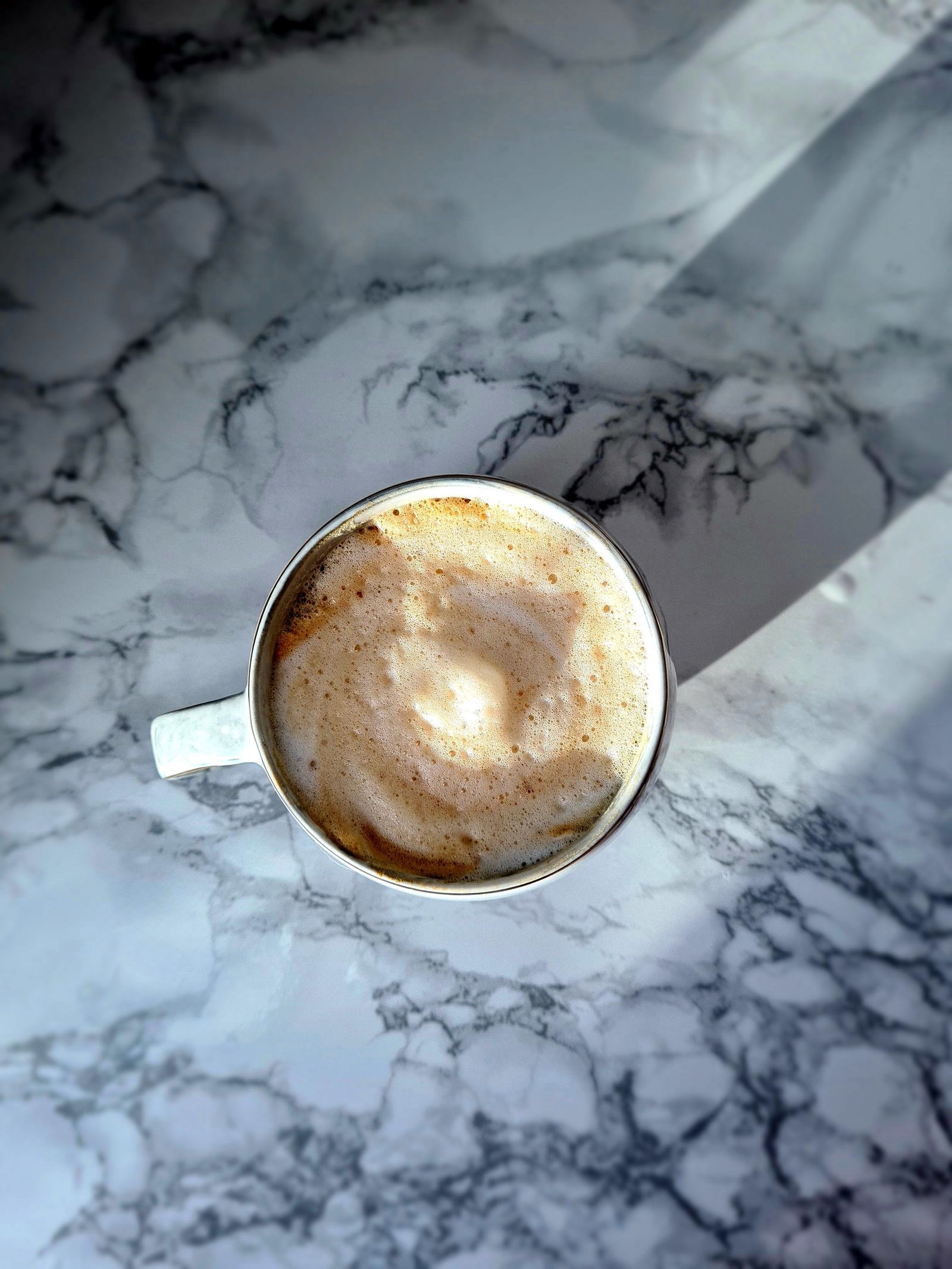Coffee cup in a warm beam of afternoon light